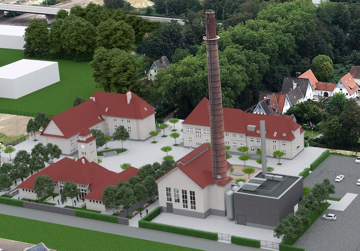 Luftaufnahme eines historischen Industrieensembles mit Schornstein und Innenhofanlage