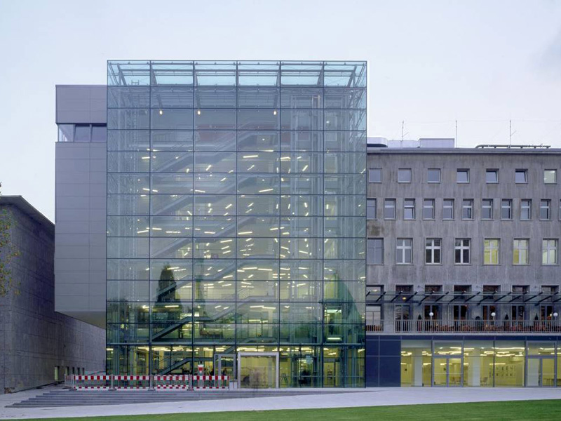 Modernes Bürogebäude mit transparenter Glasfassade und offenem Eingangsbereich